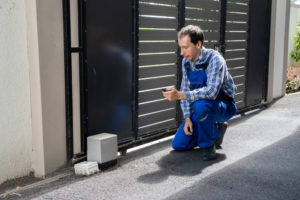 Repairman Fixing Broken Automatic Door In Building