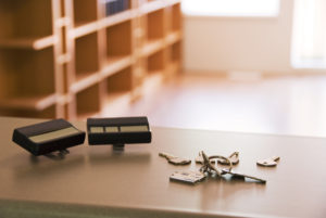 "New, empty home awaits with keys and garage door openers. Selective focus on keys."